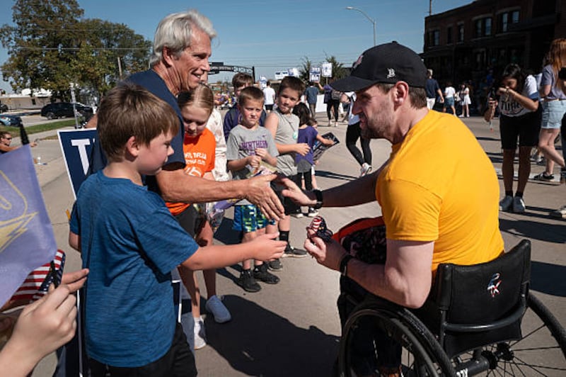 Iowa Democratic candidate for the US Senate Josh Turek greets people as he participates in the University of Northern Iowa homecoming parade on October 10th, 2026, in Cedar Falls, Iowa. Photograph: Scott Olson/Getty