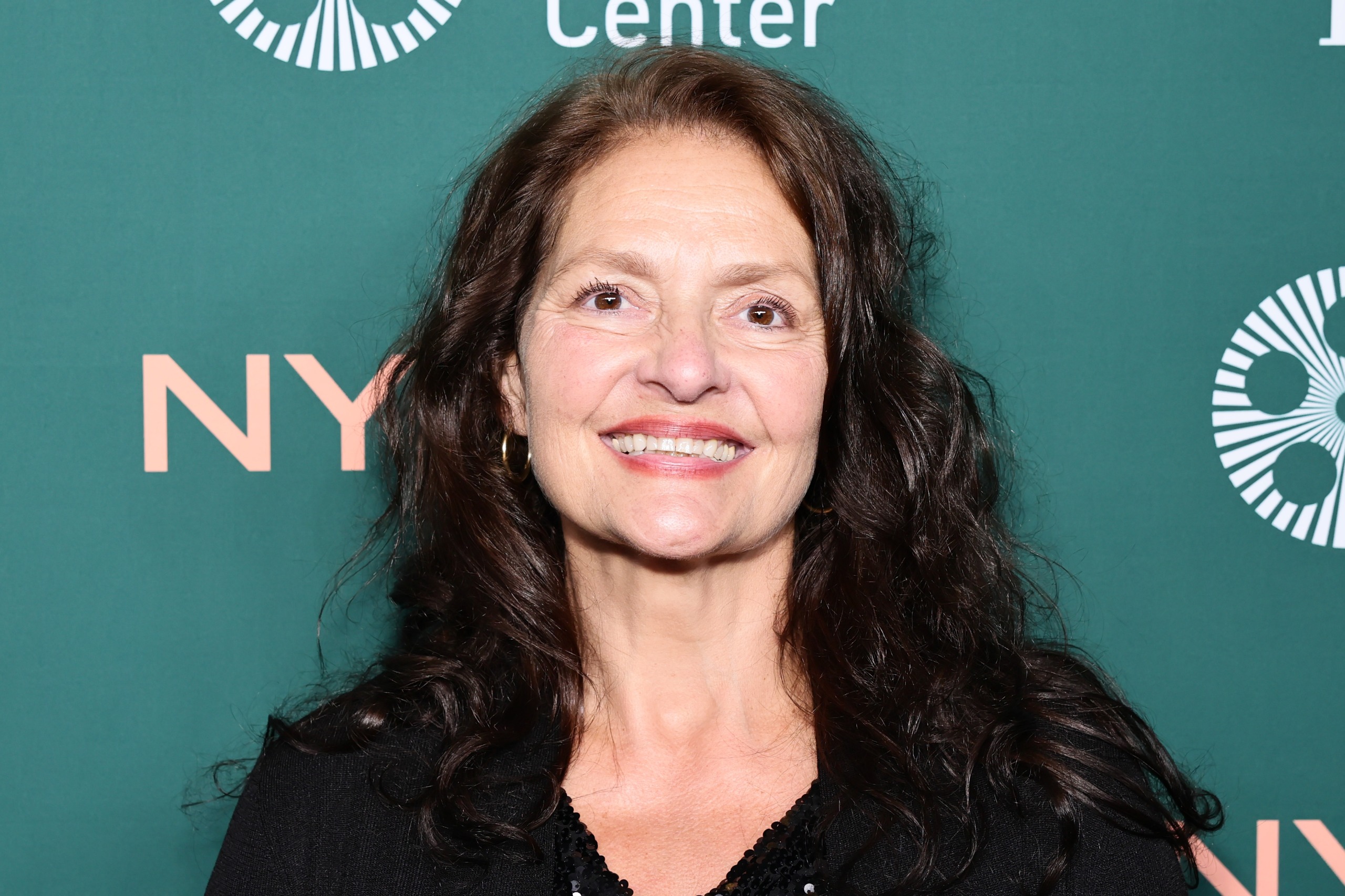 aida turturro poses on a red carpet at a new york film fest premiere