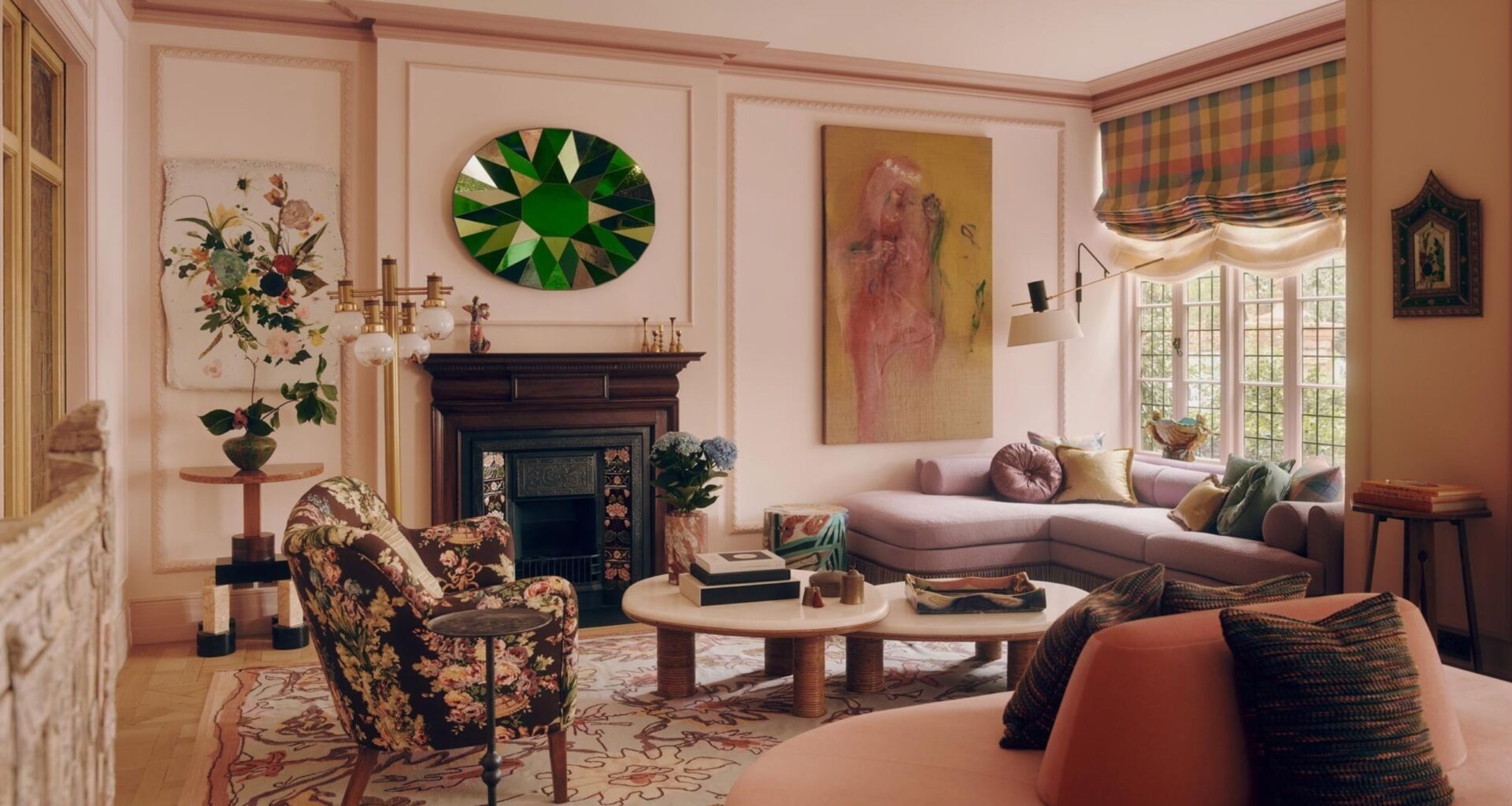 A contemporary living room, painted pink and with furniture and accessories from a mix of different eras