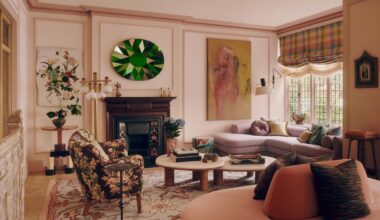 A contemporary living room, painted pink and with furniture and accessories from a mix of different eras