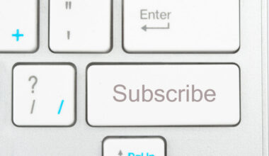 A picture of a white keyboard zoomed in on a key that says "Subscibe."
