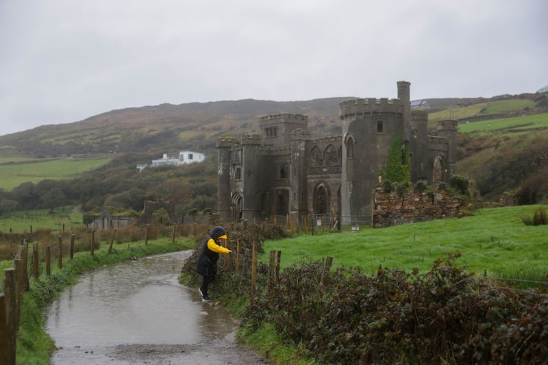 A tourist at Clifden Castle. Photograph: Enda O'Dowd