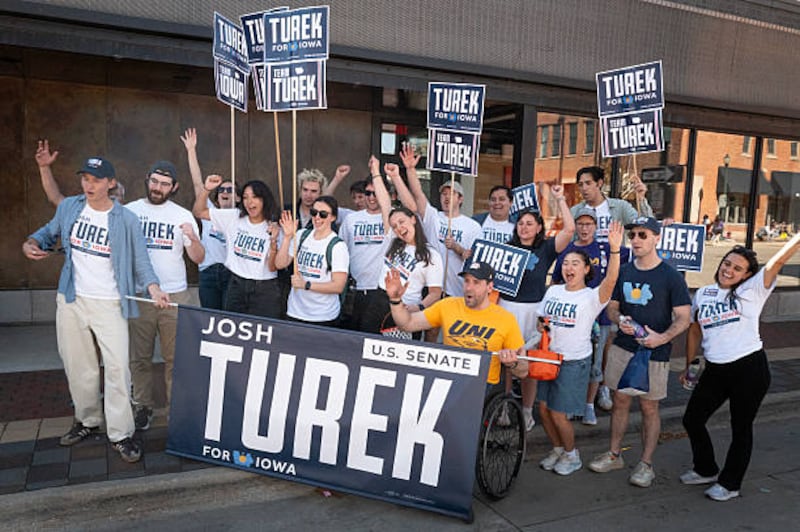 Iowa Democratic candidate Josh Turek poses for a picture with his team after they participated in the University of Northern Iowa homecoming parade in Cedar Falls, Iowa. Photograph: Scott Olson/Getty 