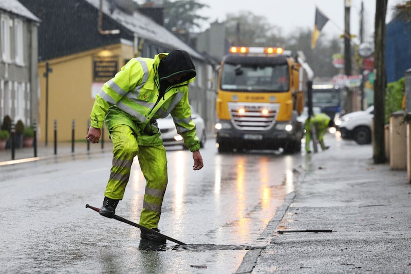 Members of Cork County Council clearing drains along the main street of Enniskeane, Co Cork  in preparation for Storm Austen, the first storm of the season. Photograph: Alan Betson/The Irish Times


