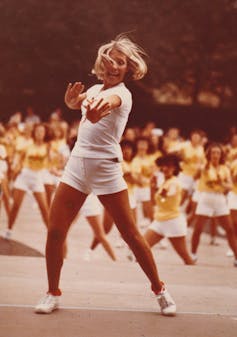 Jacki Sorensen leading an aerobics dance class at an event.