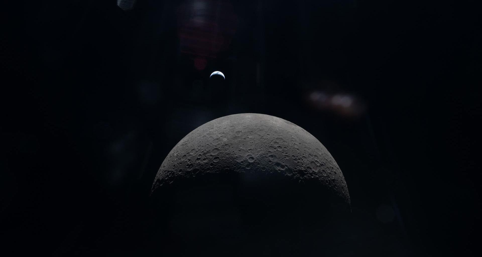 A view of the moon with the Earth in the background
