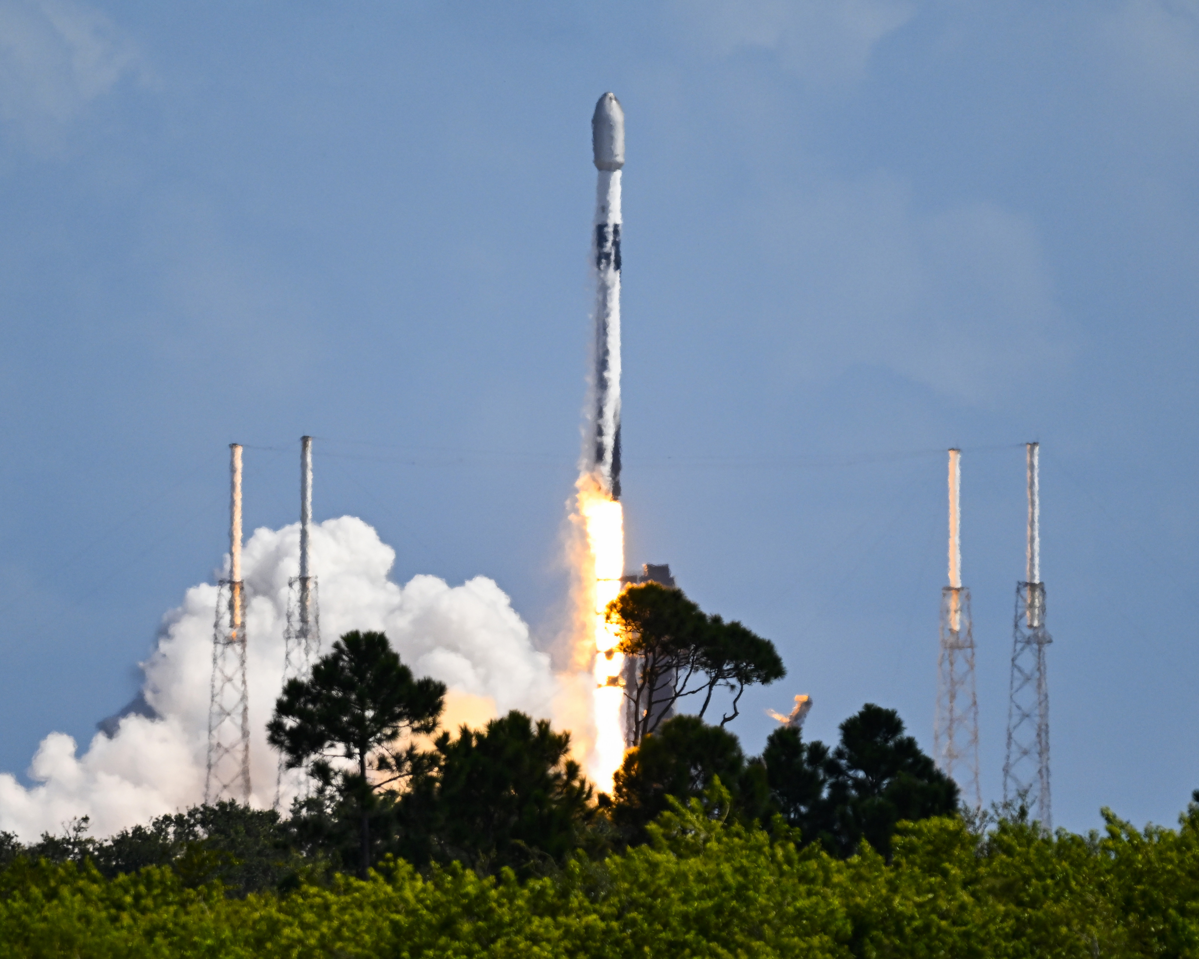 SpaceX Falcon 9 rocket launching 28 Starlink satellites from Cape Canaveral Space Force Station.