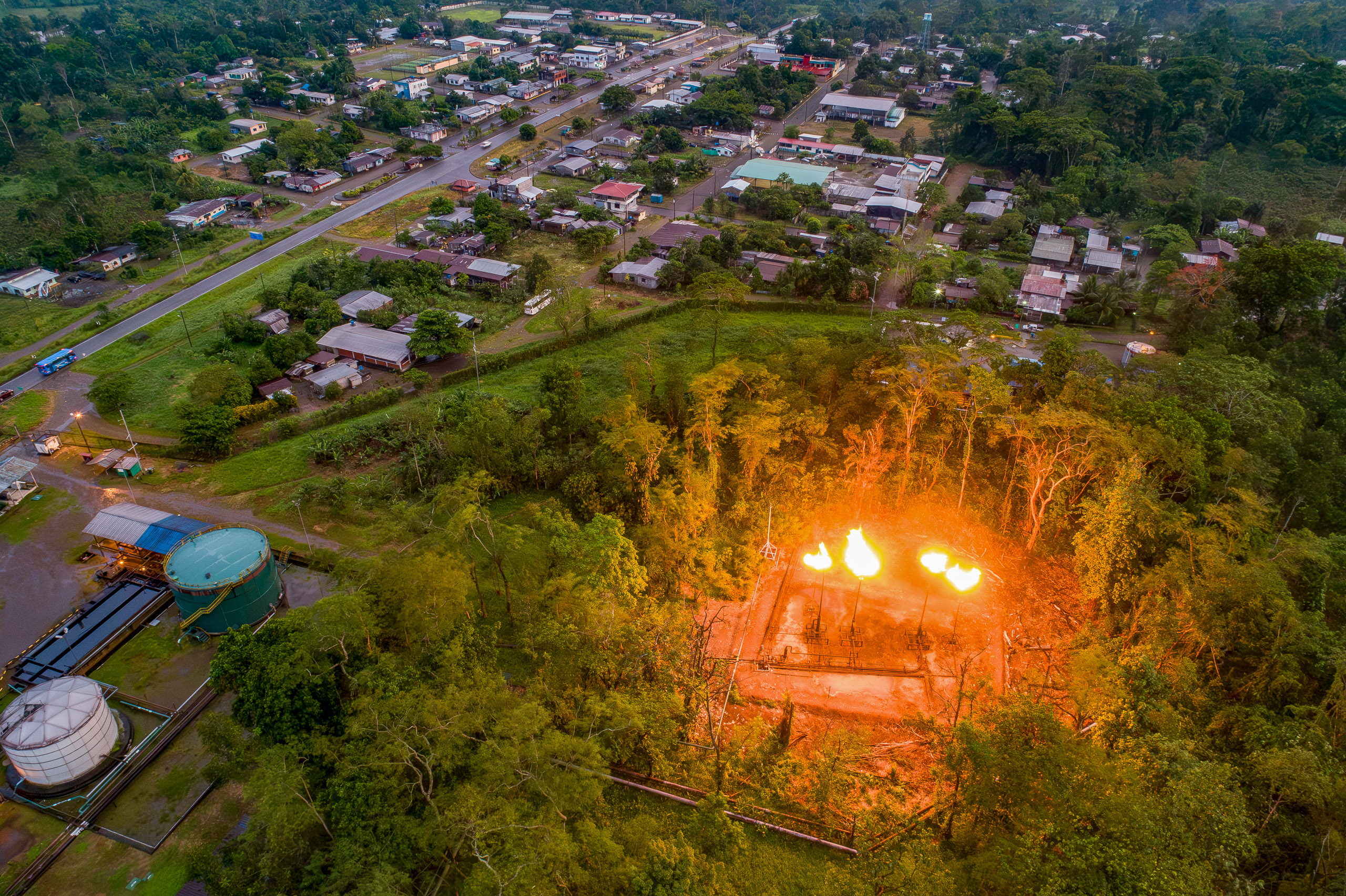 Aerial view of a burning oil well in the rainforest