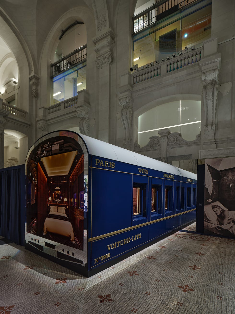 A luxury train car exhibit within an ornate interior space.