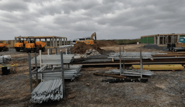 a parking lot filled with equipment and junk