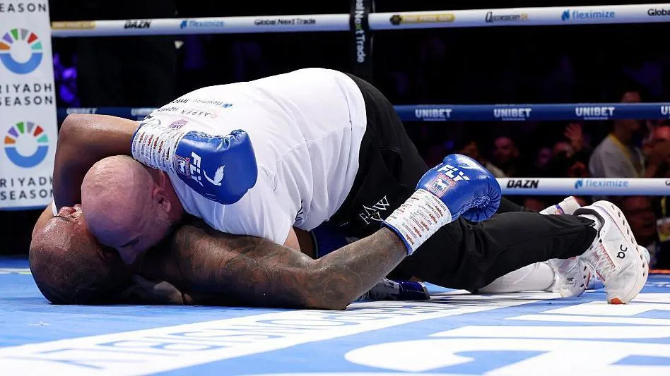 Fabio Wardley is hugged by his coach in the ring