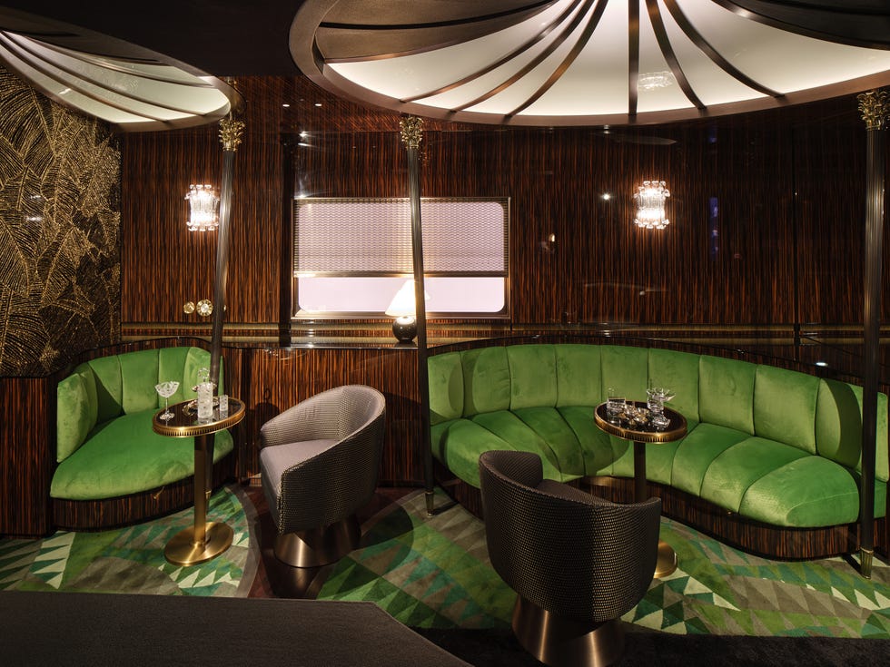 Sophisticated lounge area featuring green seating and elegant decor.
