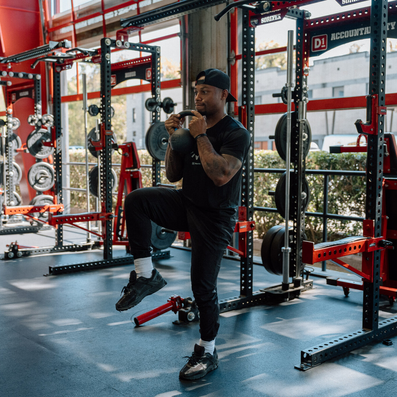 Man demonstrates kettlebell exercise in gym