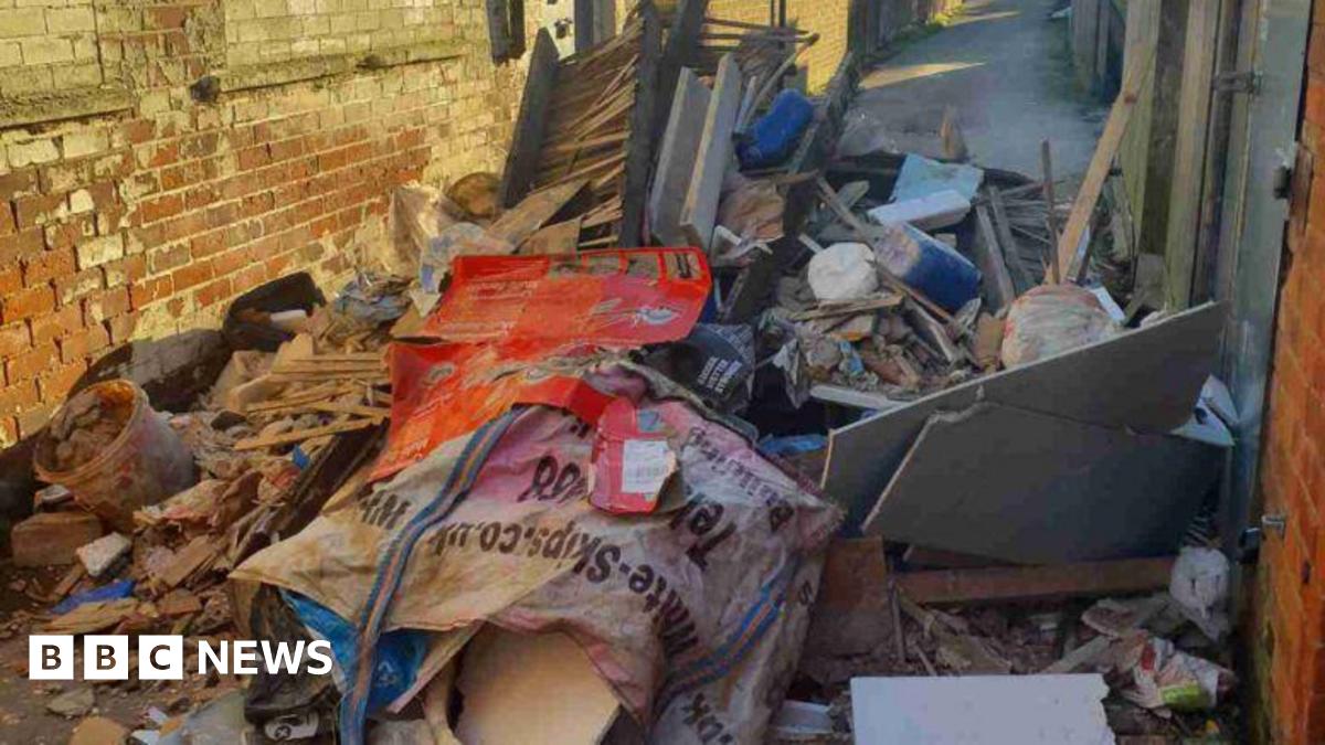 A large amount of construction waste dumping in a small street.