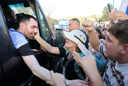 People greet Guy Gilboa-Dalal as he returns home after two years in Gaza, in Alfei Menashe, on Sunday.