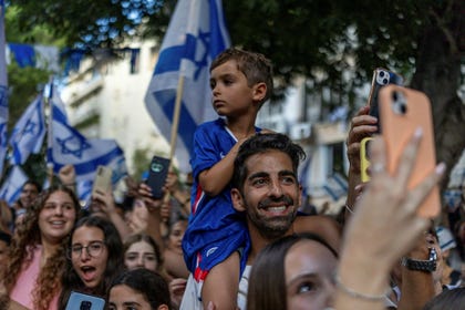 People celebrate as released hostage Evyatar David returns home, in Kfar Sava, on Sunday.