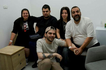 Released hostage Yosef Chaim Ohana, center, reunites with his family, on Monday.