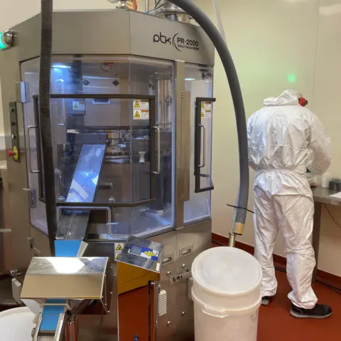 Ruth Clegg/BBC A pill presser machine which compresses the powder into tablets