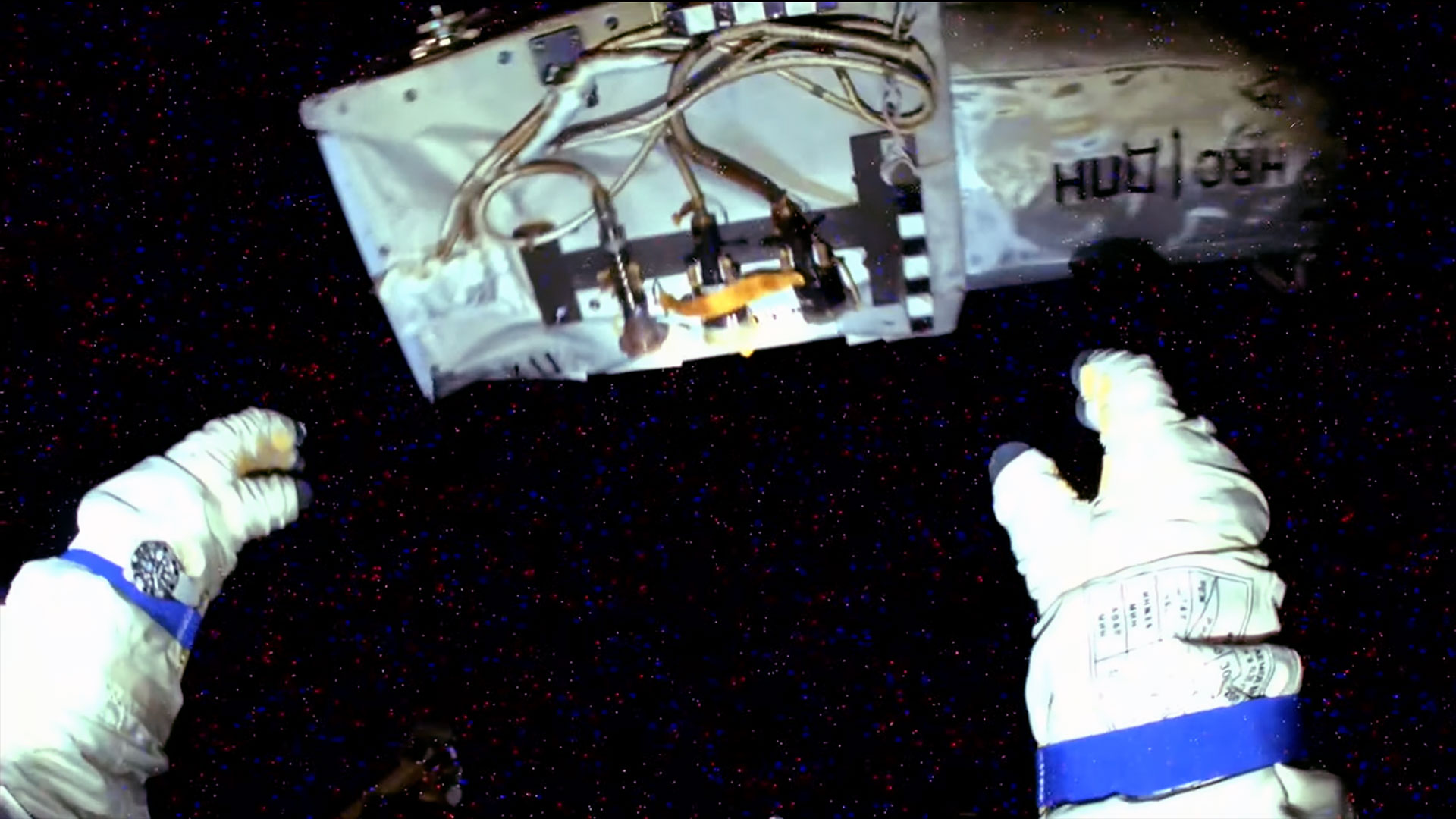 a camera mounted on the helmet of a cosmonaut's spacesuit captured this view of the cosmonaut's hands after he jettisoned a camera unit into the vacuum of space.