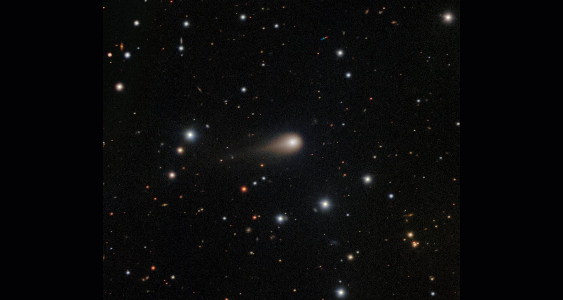 A streak of white shows interstellar comet 3I/ATLAS in the center of a starry night sky