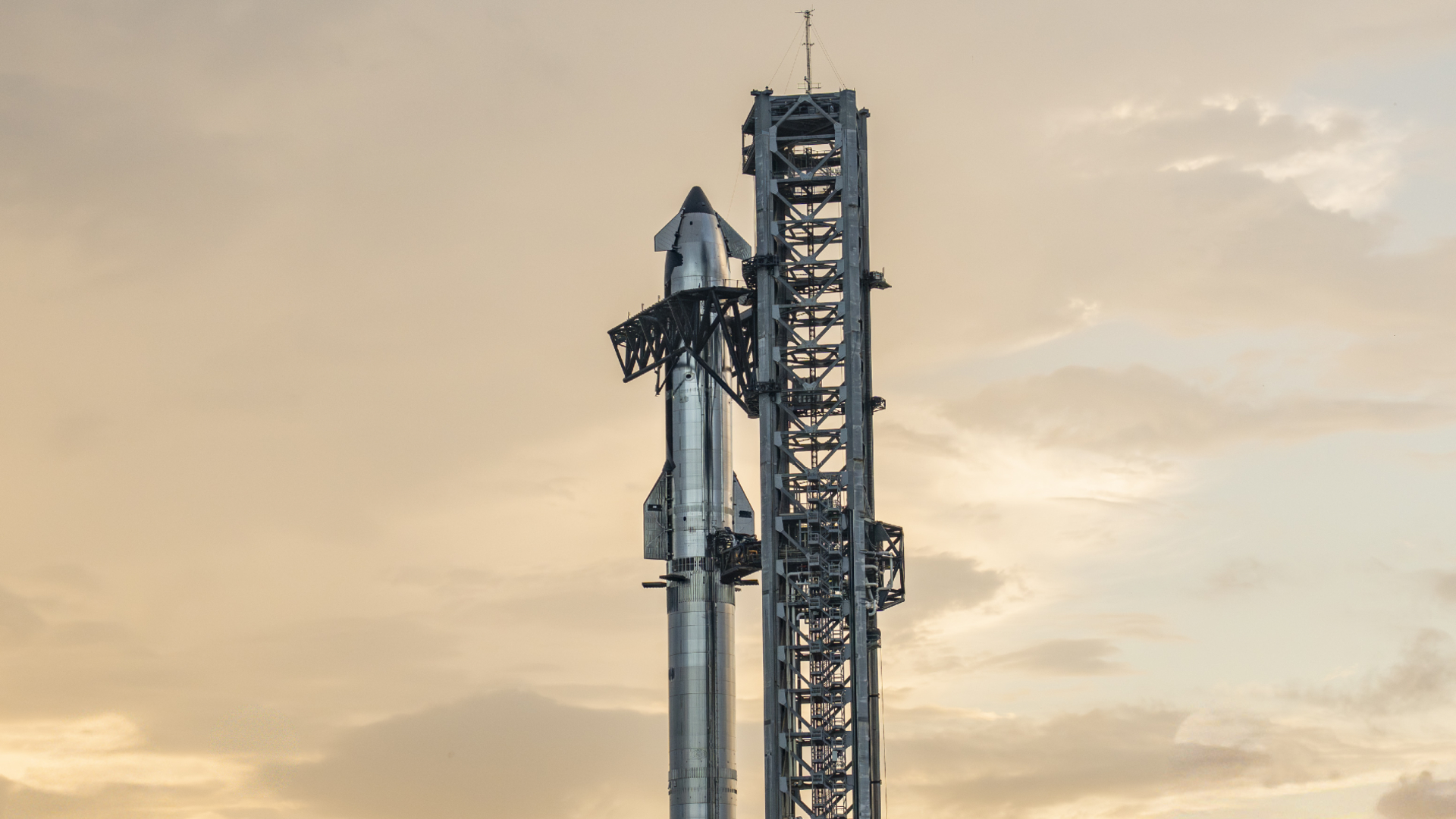 SpaceX's Starship Flight 10 Ship atop its Super Heavy rocket at dusk