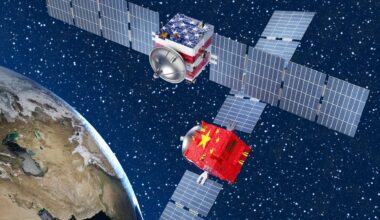 Two satellites with solar panels on either side, one with a USA flag and one with a Chinese flag, hover above Earth in this illustration