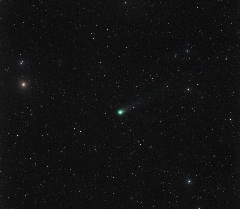 Starfield with a small, fuzzy green glowing object with a barely perceptible short tail.