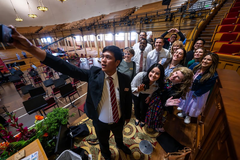 Kierby Jocobo Nanol holds up his phone to take a photo with other global members of The Tabernacle Choir at Temple Square. The group discussed their musical histories and how they felt about the opportunity to be members of the choir during an interview in the Tabernacle in Salt Lake City on Tuesday, Sept. 23, 2025.