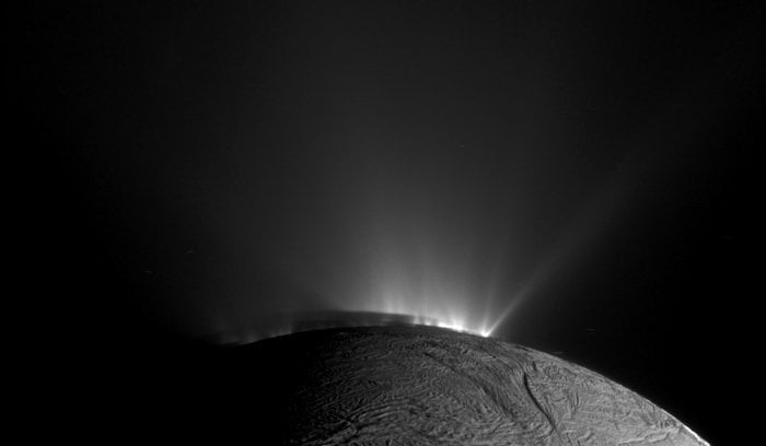 Enceladus with a glow from the Sun highlighting its jets. Credit - NASA / JPL-Caltech / SSI