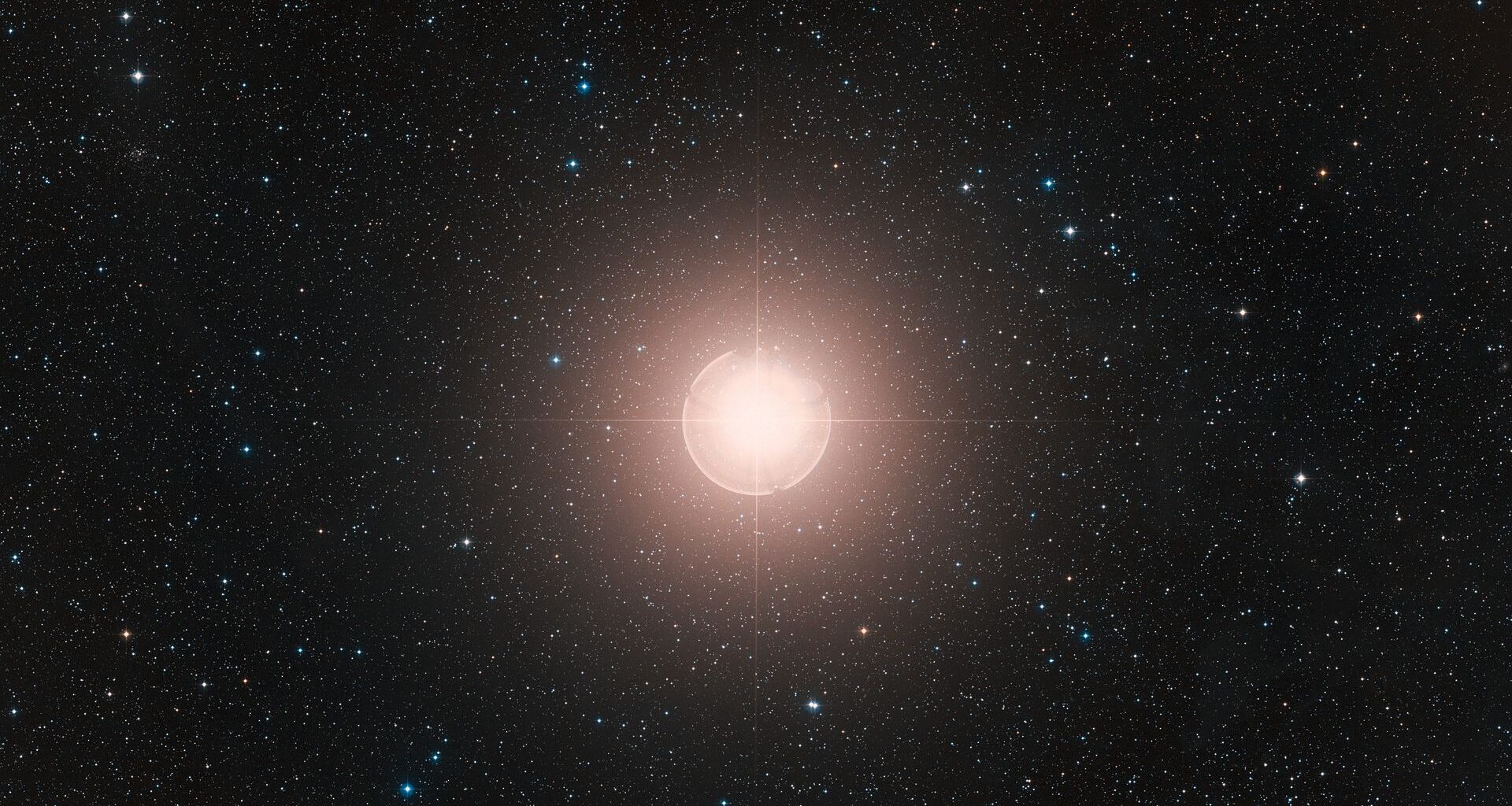 This image of Betelgeuse is a color composite made from exposures from the Digitized Sky Survey 2 (DSS2). A bright ball of light glows in the middle of deep space