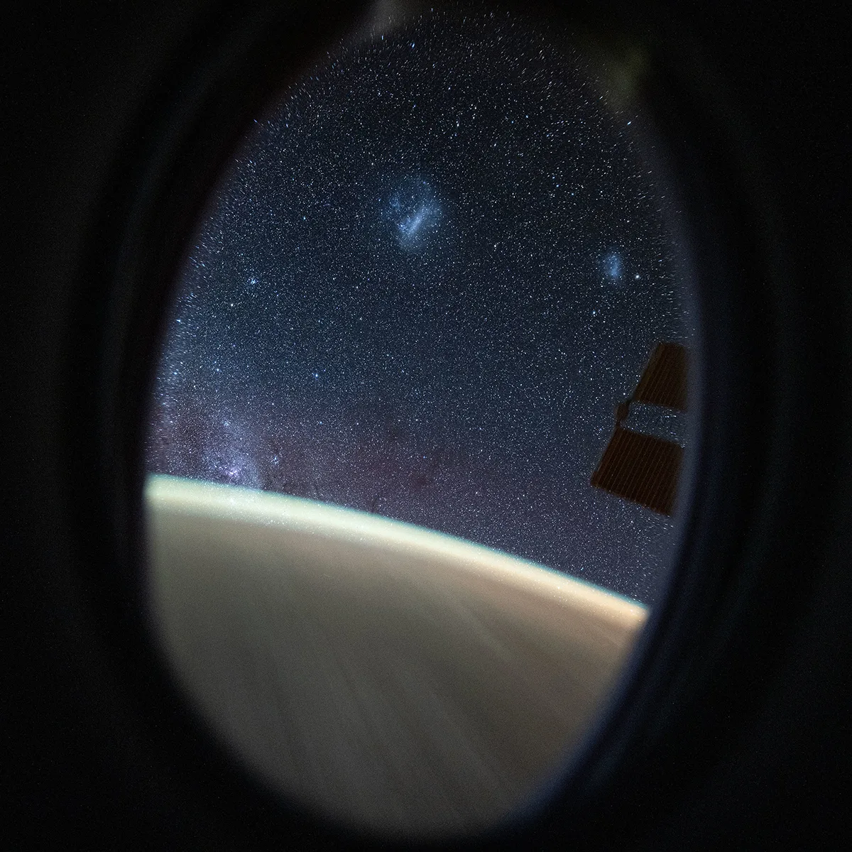 A view of the Southern Hemisphere sky, captured by astronaut Don Pettit on board the Space Station. Two fuzzy blobs at the top are the Large and Small Magellanic Clouds. The denser population of stars bottom left is the Milky Way. Credit: NASA/Don Pettit