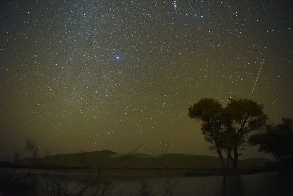 An Orionid meteor in Bayingolin, China, 21 October 2020. Photo by Xue Bing/VCG via Getty Images