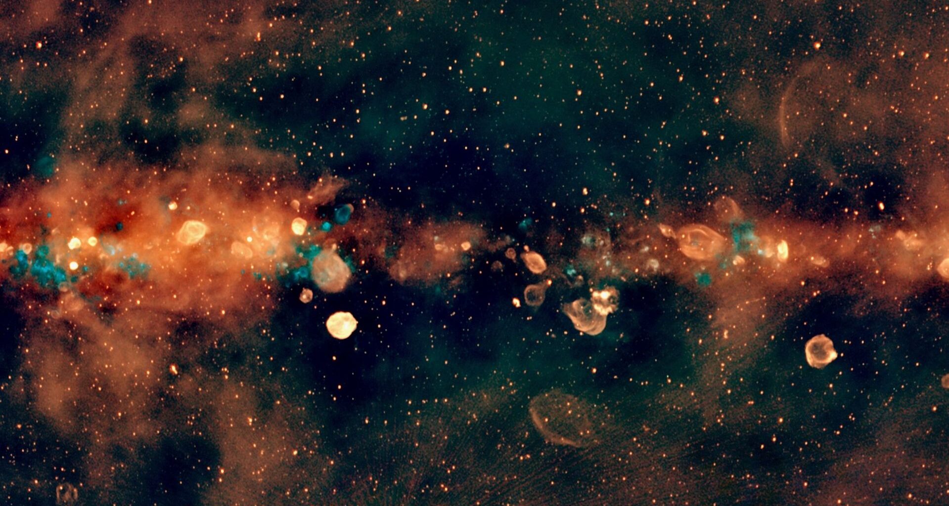 radio telescope view of the milky way's central band, showing it as an orange cloud studded with orange and blue spheres