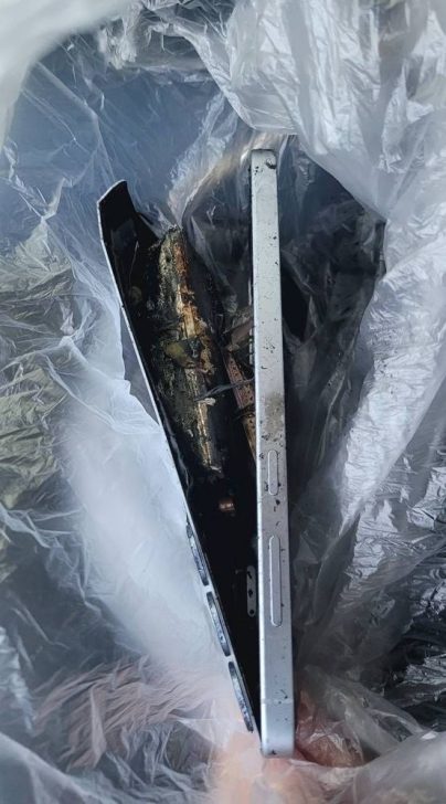 Damaged unbranded smartphone in a plastic bag.