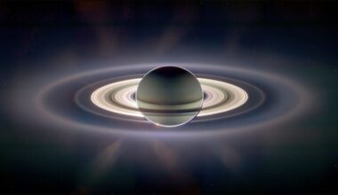 The orb of Saturn and its extensive ring system with the planet showing through the rings and a glow behind it all.