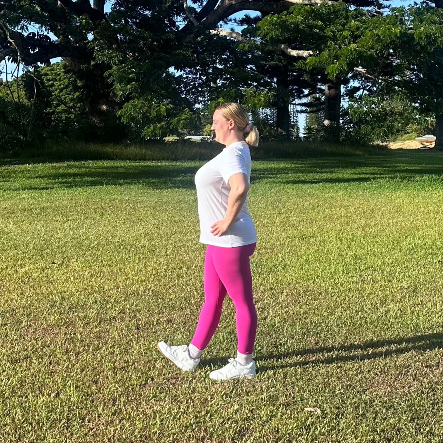 Woman demonstrating stretches on grass