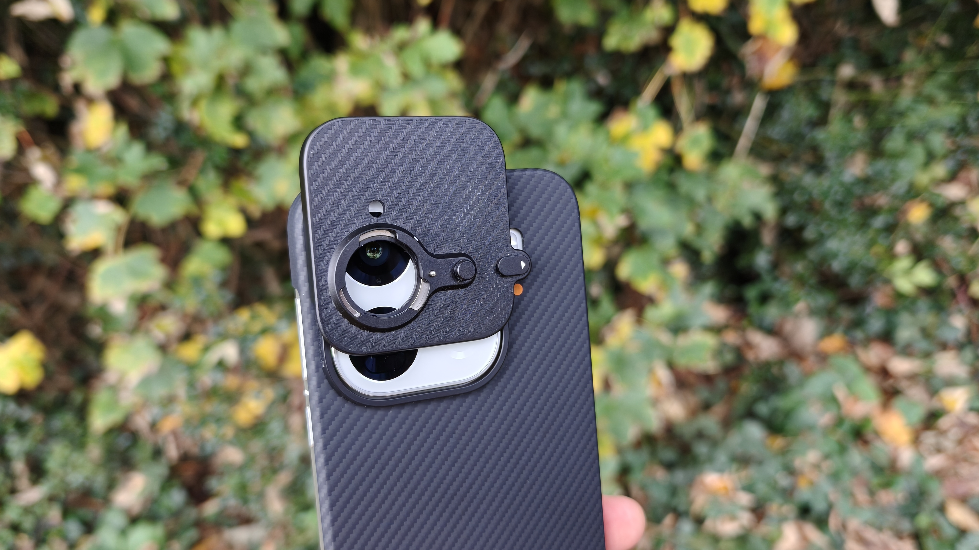 Oppo Find X9 Pro with the extender lens mount partially attached 