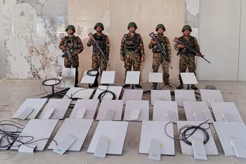 In this image provided by the Myanmar military on Oct. 19, 2025, soldiers stand next to Starlink machines during a raid on KK Park in Myawaddy township, Karen State, Myanmar.