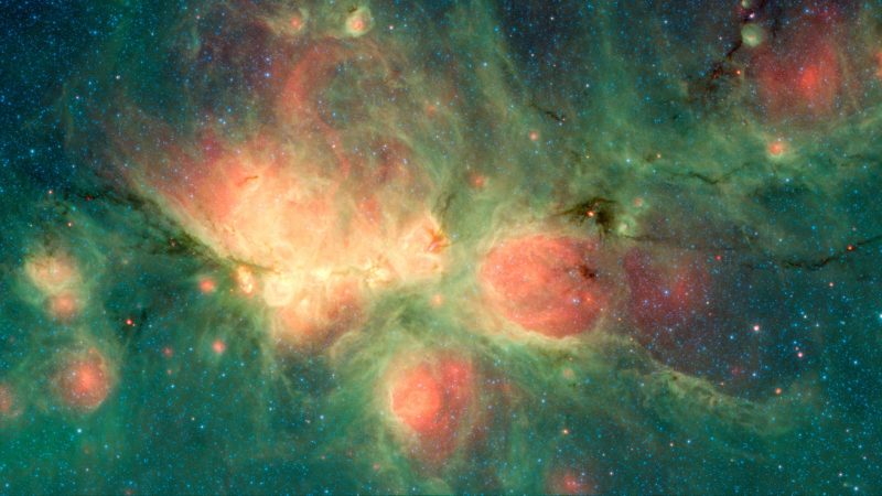 Roundish pink nebulas within swirling green dust clouds, among scattered stars.
