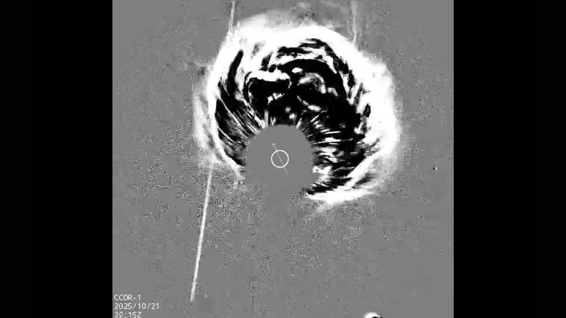 A gray scale image shows a plume of energy coming from the center of the image