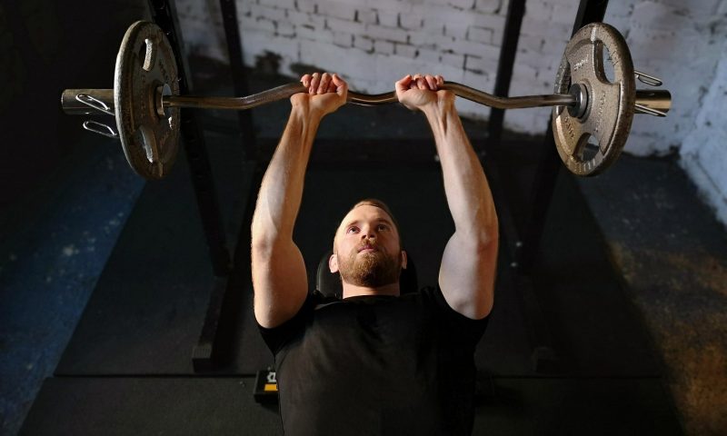 man lifting barbell bench press lift