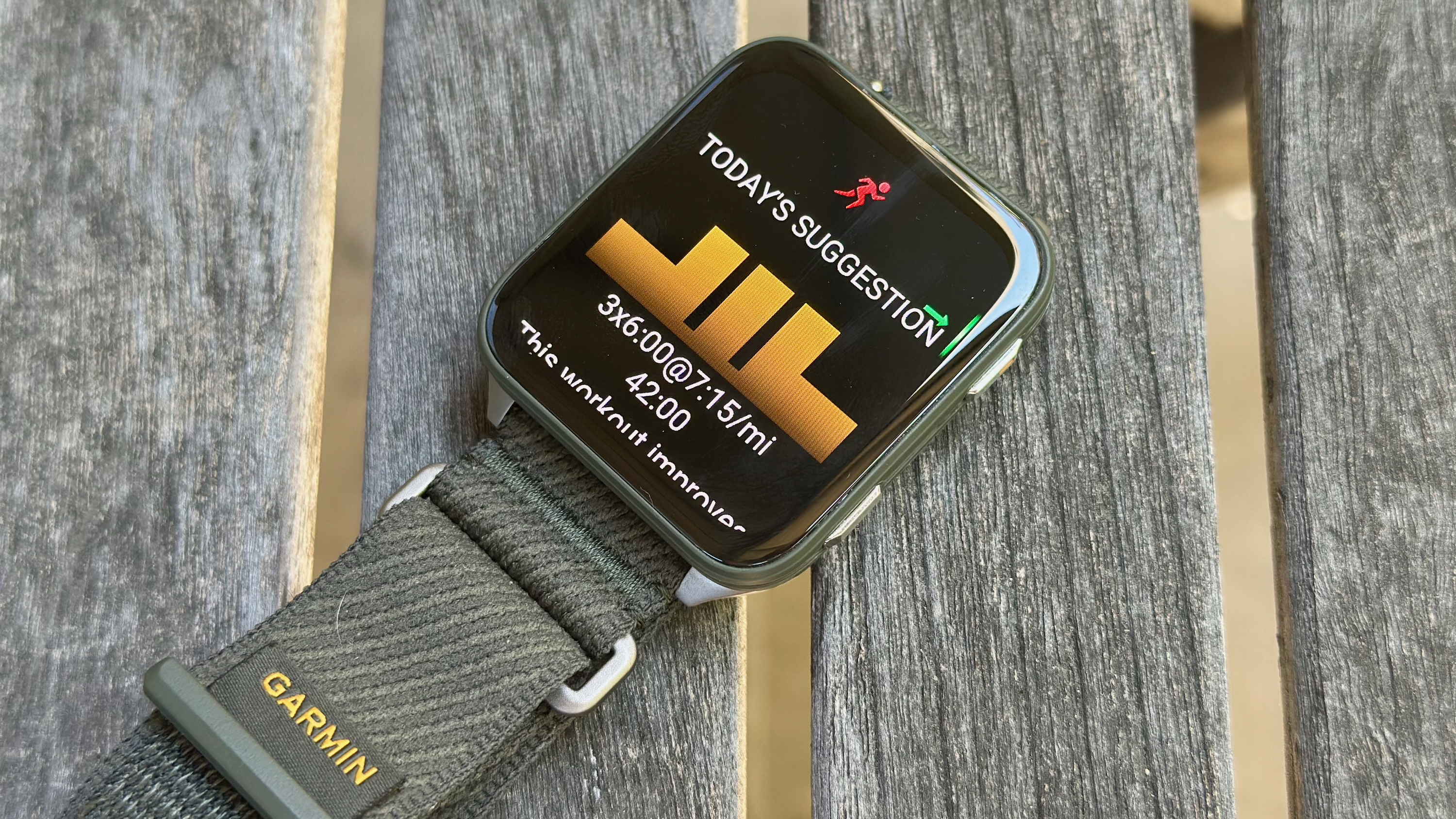 The Garmin Venu X1 sitting on a table, with the daily suggested workout visible.