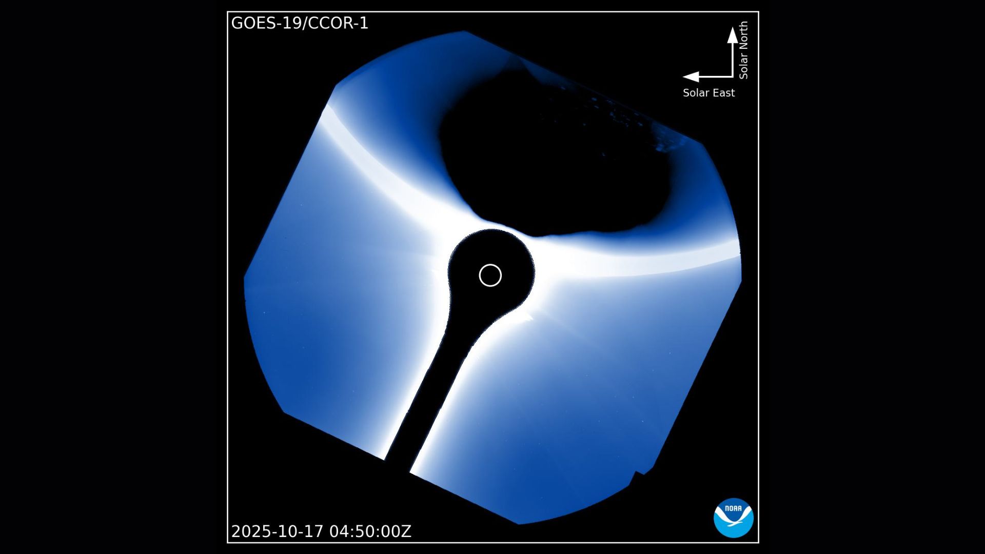 A black shadow is seen at the top right of the image with a blue halo of light in the middle where the coronagraph is