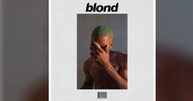 A shirtless person with short green hair covers their face with one hand, standing against a tiled background. The word "blond" is written above, resembling an album cover design.
