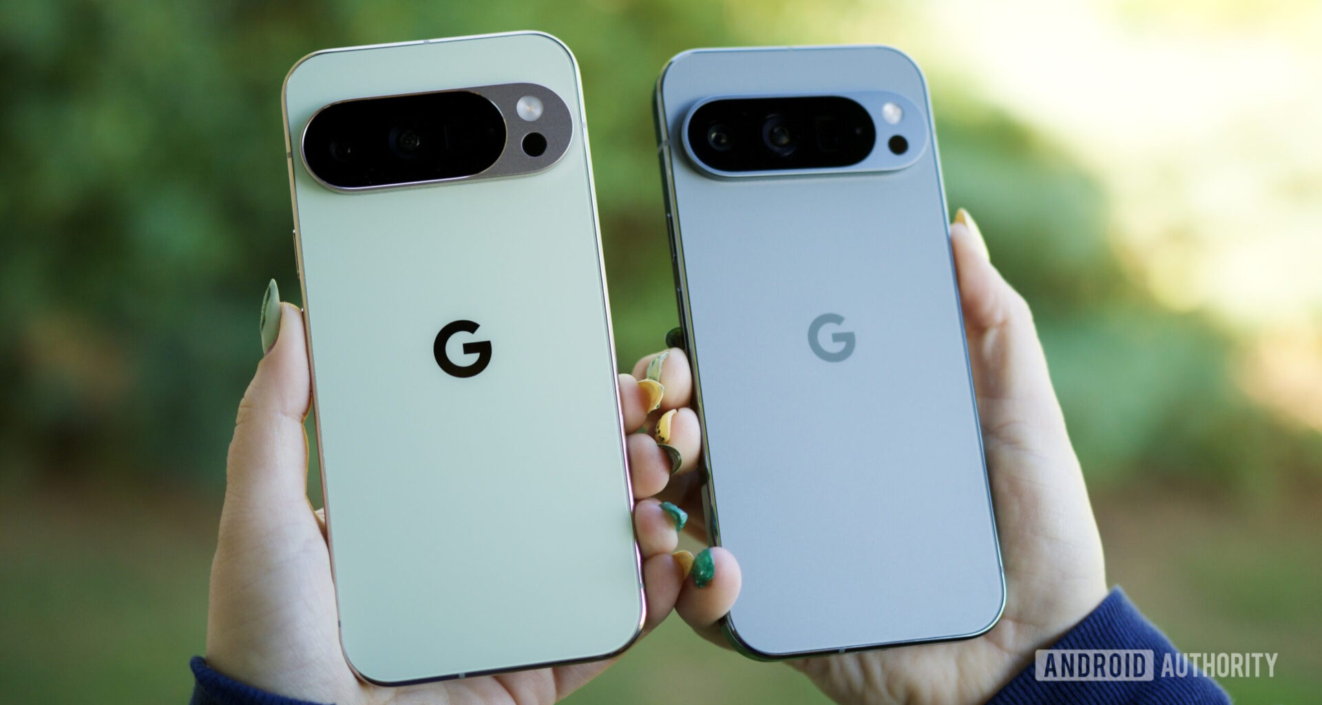 Someone holding the Pixel 10 Pro and Pixel 9 Pro, showing the backs of the phones.