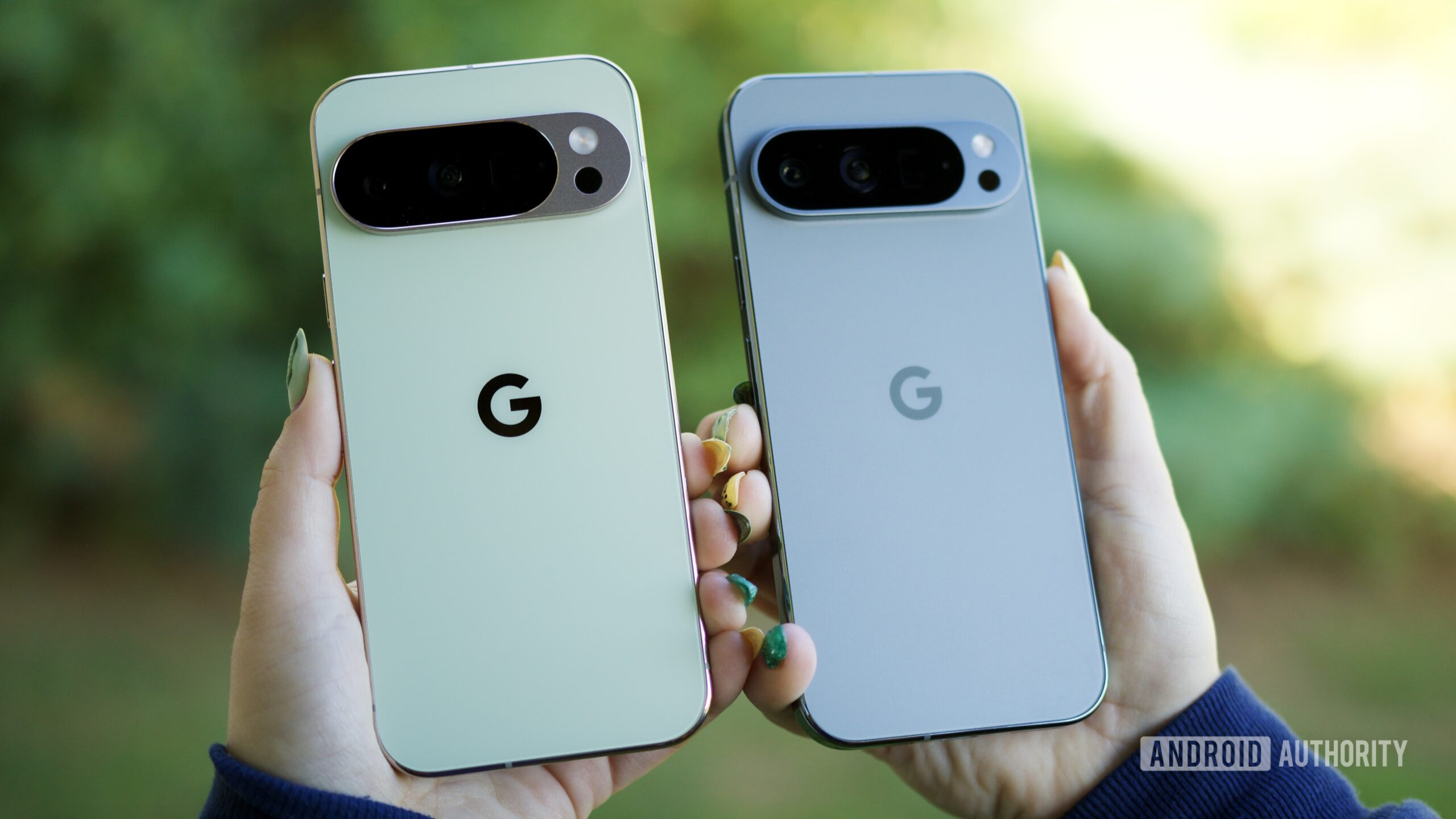 Someone holding the Pixel 10 Pro and Pixel 9 Pro, showing the backs of the phones.