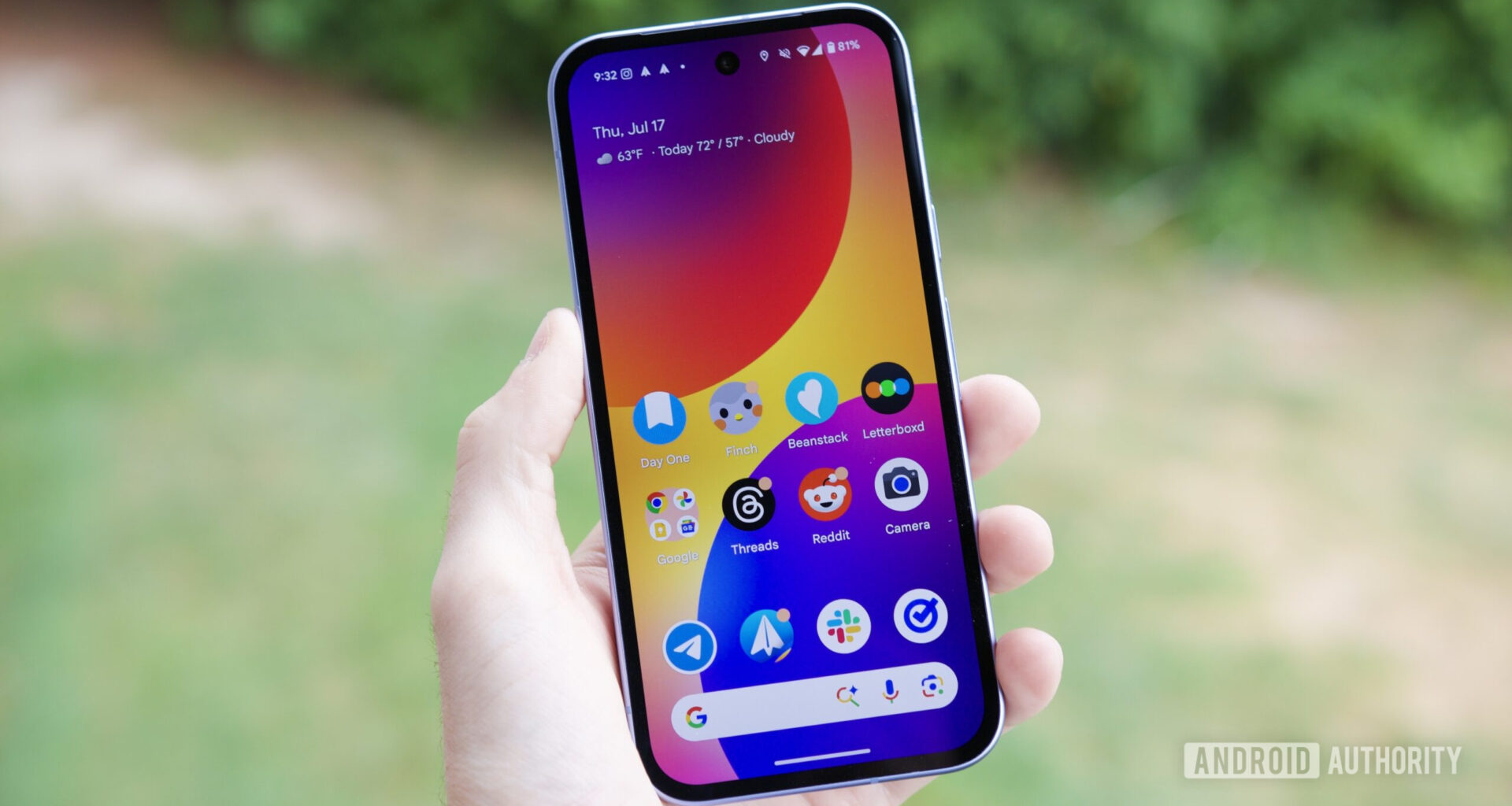 Someone holding a Google Pixel 9a with its screen on.