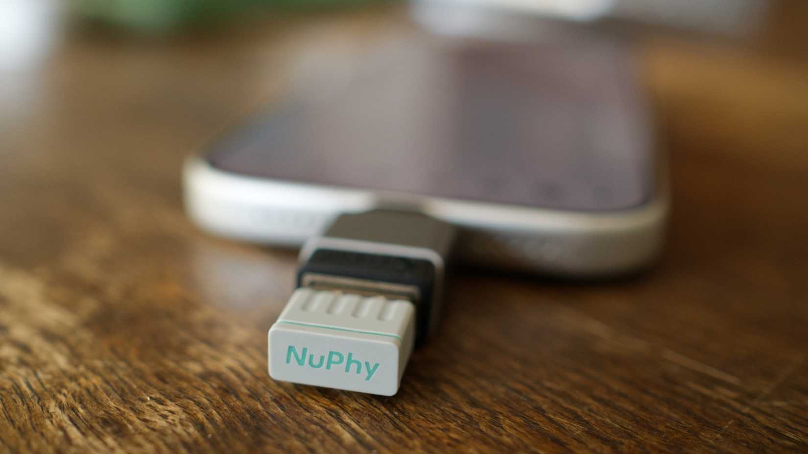 iPhone 17 Pro with a NuPhy 2.4GHz wireless dongle.