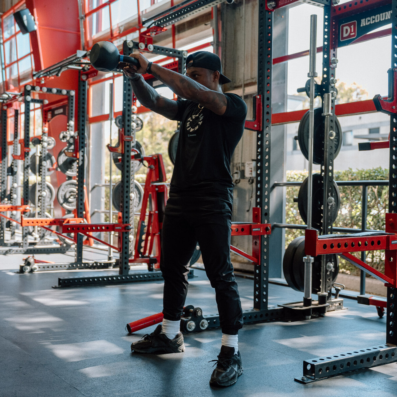 Man demonstrates kettlebell exercise in gym