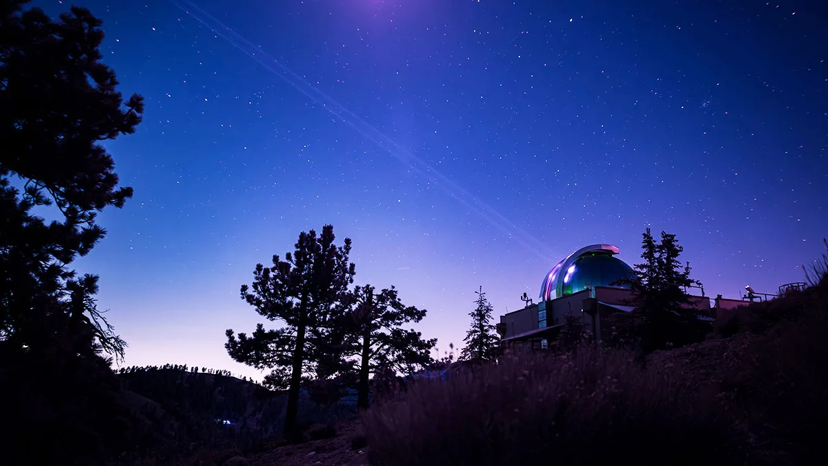 Infrared image showing the Optical Communications Telescope Laboratory at NASA JPL's Table Mountain Facility beaming a laser beacon to the DSOC flight laser transceiver aboard NASA's Psyche spacecraft. Credit: NASA/JPL-Caltech